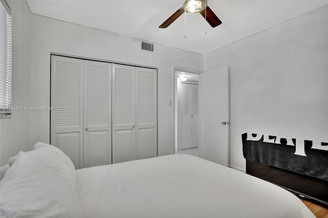 bedroom featuring ceiling fan, a closet, and light hardwood / wood-style floors