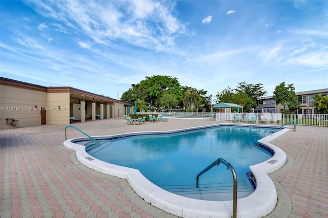 view of swimming pool with a patio area