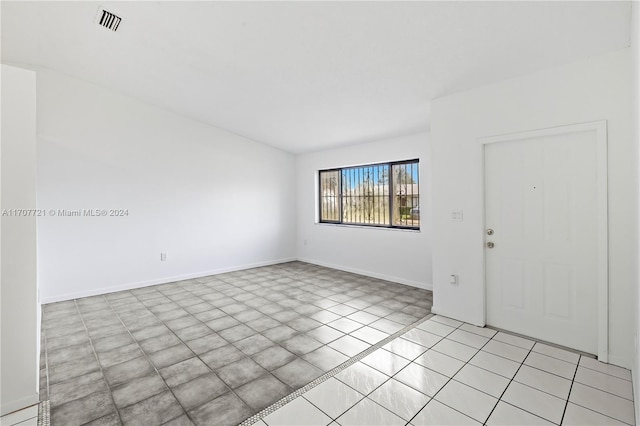 empty room with light tile patterned floors