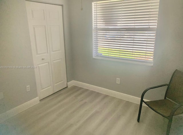 sitting room with wood-type flooring