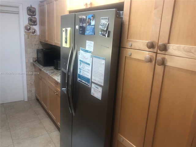 kitchen featuring stainless steel fridge with ice dispenser, light stone counters, light brown cabinetry, and light tile patterned flooring