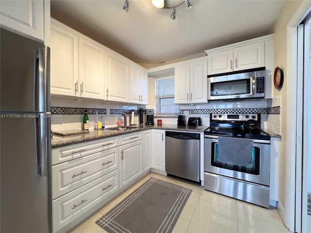 kitchen featuring white cabinetry, stainless steel appliances, and tasteful backsplash