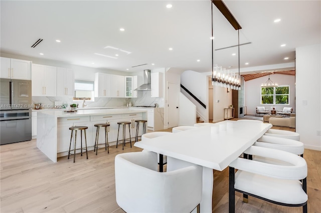 dining space with a chandelier, light hardwood / wood-style flooring, and sink