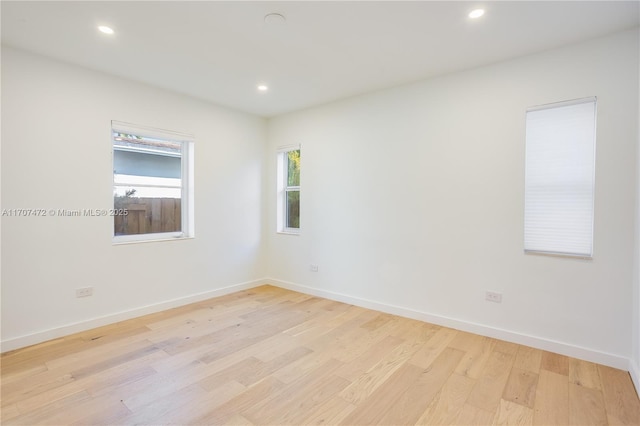 spare room with light hardwood / wood-style flooring