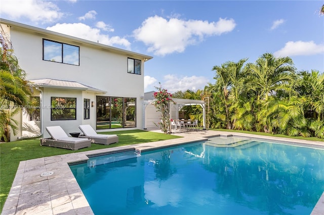 view of pool with a yard and a patio