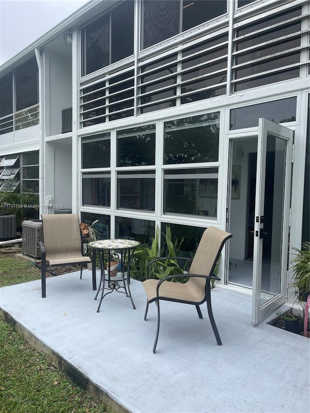 view of patio with central AC unit and french doors