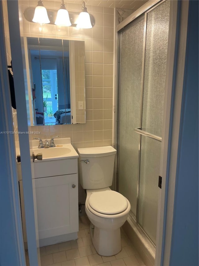 bathroom featuring vanity, tasteful backsplash, tile patterned floors, and tile walls