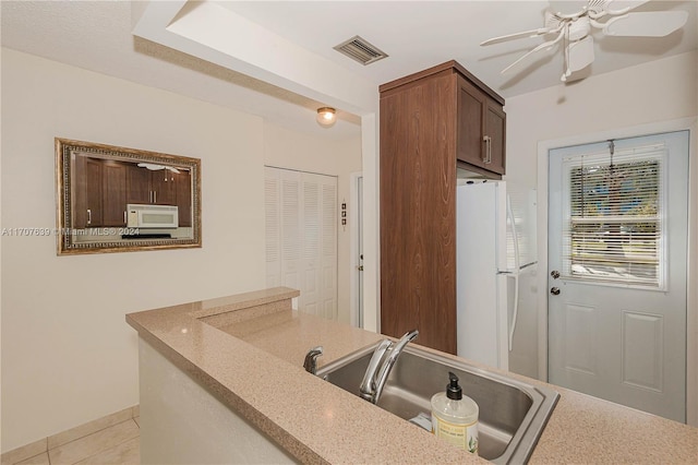 kitchen with ceiling fan, sink, light tile patterned floors, and white appliances