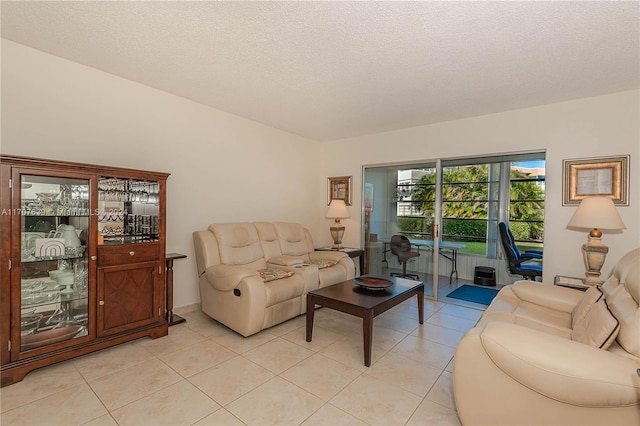 living room featuring light tile patterned flooring and a textured ceiling