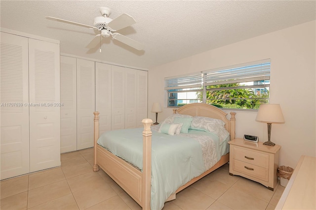 tiled bedroom featuring ceiling fan and a textured ceiling