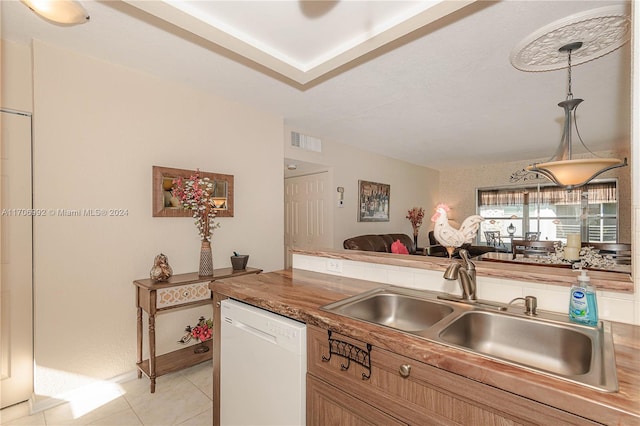 kitchen featuring dishwasher, light tile patterned floors, pendant lighting, and sink