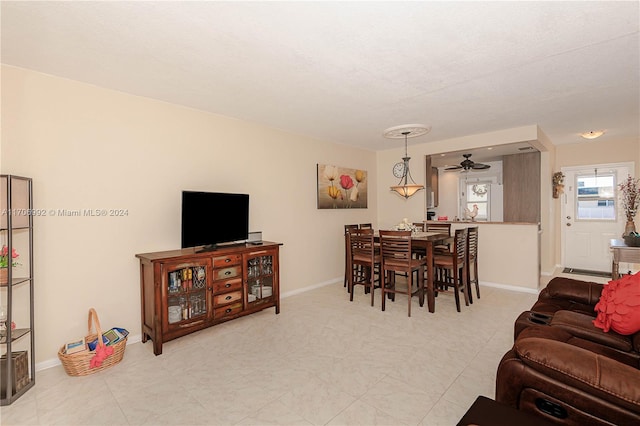 living room with a textured ceiling and ceiling fan