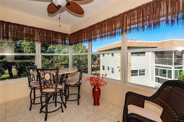 sunroom / solarium with a wealth of natural light and ceiling fan