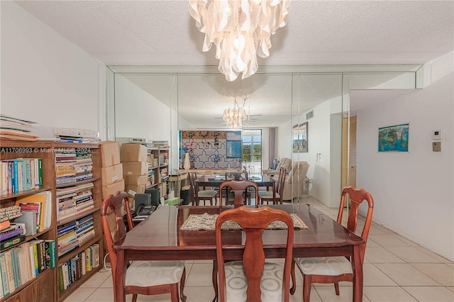 tiled dining area with a chandelier and a textured ceiling