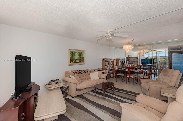 living room featuring tile patterned floors, ceiling fan, and a textured ceiling