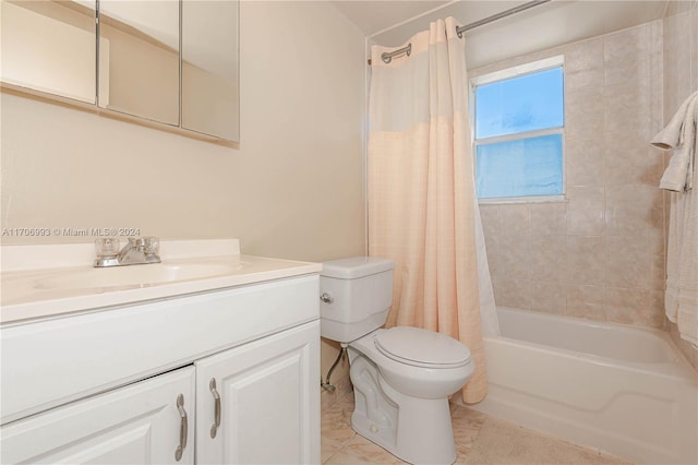 full bathroom featuring tile patterned floors, shower / tub combo with curtain, vanity, and toilet