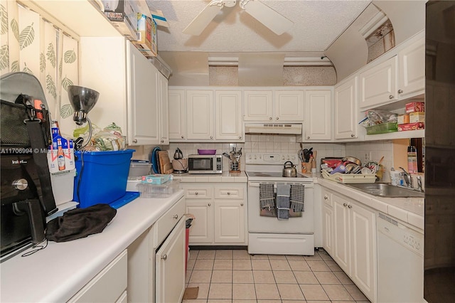 kitchen featuring light tile patterned floors, white appliances, a textured ceiling, and white cabinetry