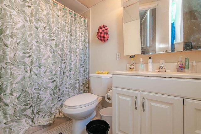 bathroom featuring tile patterned flooring, a shower with curtain, vanity, and toilet