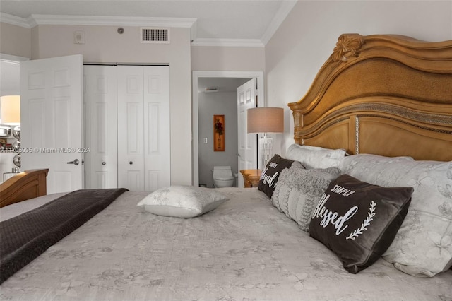 bedroom with ensuite bath, a closet, and ornamental molding