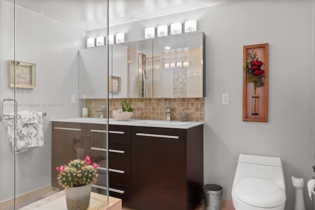 bathroom with decorative backsplash, vanity, toilet, and walk in shower