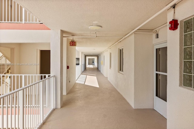 corridor with a textured ceiling