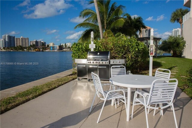 view of patio / terrace with area for grilling and a water view