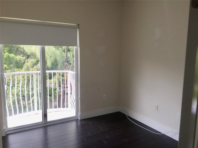 spare room with dark wood-type flooring and a healthy amount of sunlight