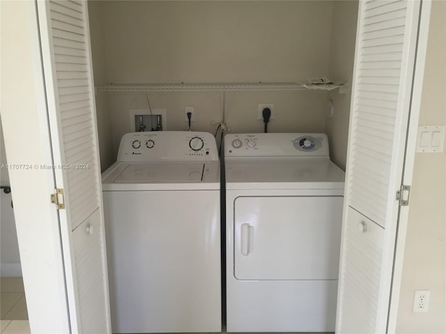 laundry room featuring tile patterned flooring and separate washer and dryer