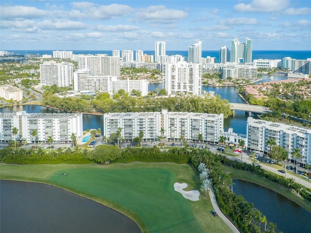 birds eye view of property with a water view and a city view