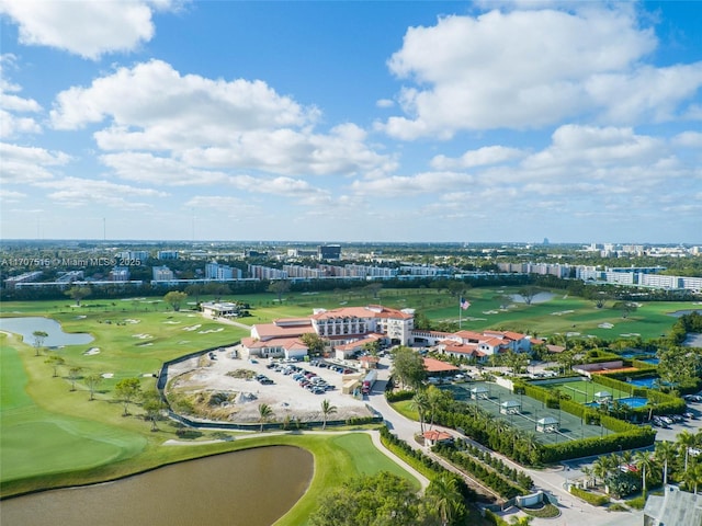 aerial view with golf course view and a water view
