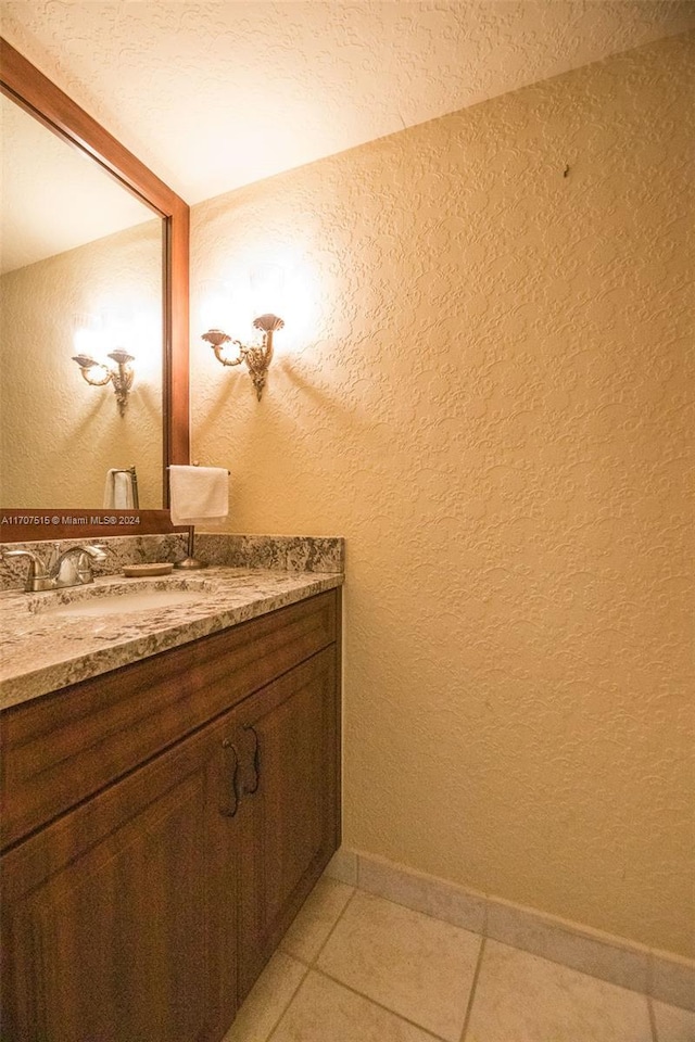 bathroom with vanity, a textured ceiling, and tile patterned floors