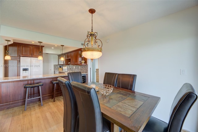 dining area featuring light wood finished floors