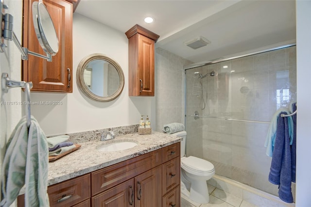 bathroom featuring a shower stall, tile patterned floors, toilet, and vanity