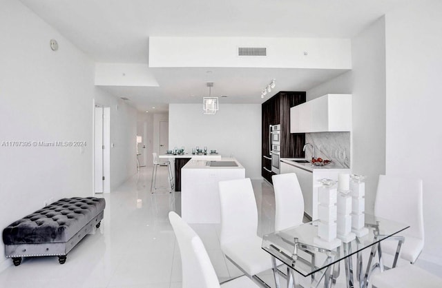 tiled dining room with sink