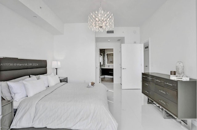 bedroom with a chandelier and connected bathroom