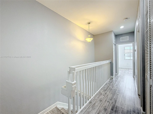 hall with hardwood / wood-style flooring