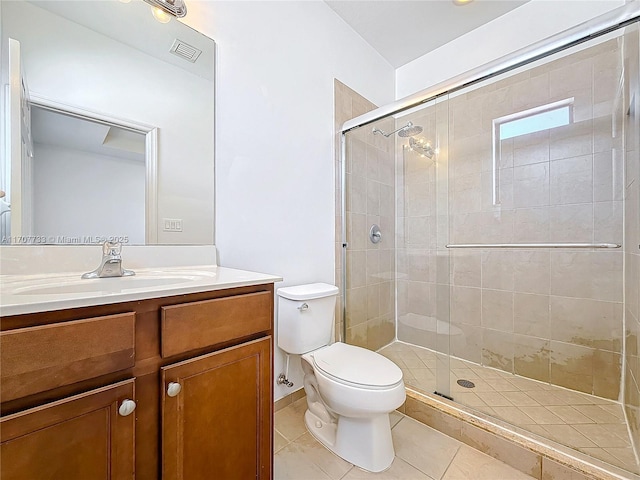 bathroom with tile patterned flooring, vanity, a shower with shower door, and toilet