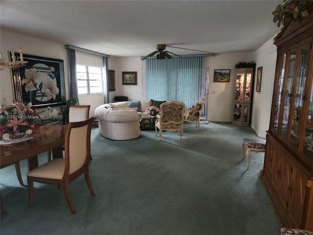 carpeted living room with ceiling fan with notable chandelier and a textured ceiling