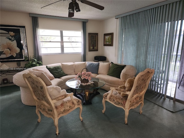 carpeted living room with ceiling fan and a textured ceiling