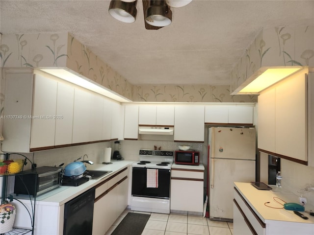 kitchen featuring sink, white appliances, light tile patterned floors, white cabinetry, and a textured ceiling