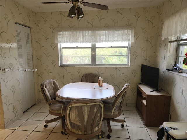 tiled dining area with ceiling fan