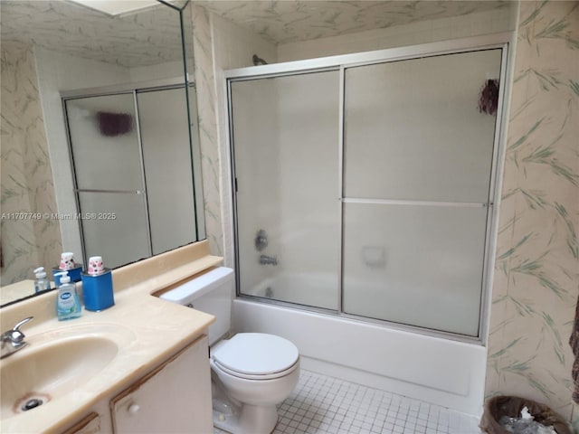 full bathroom with enclosed tub / shower combo, vanity, tile patterned flooring, and toilet