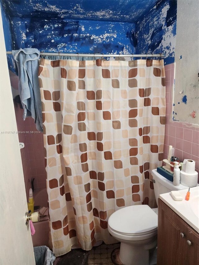 317 NW 3rd St, Deerfield Beach, FL 33441 - bathroom with vanity, tile walls, and toilet