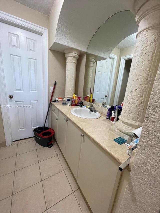 bathroom featuring a textured ceiling, vanity, and tile patterned floors