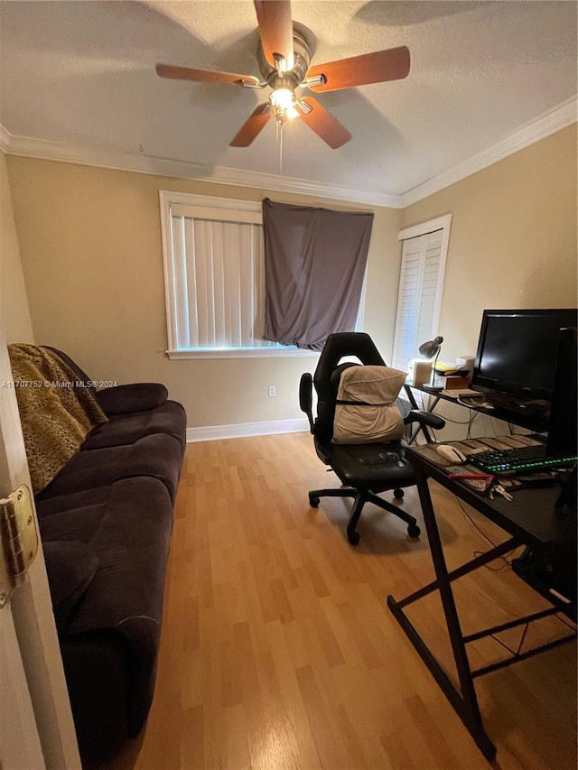 home office featuring ceiling fan, ornamental molding, a textured ceiling, and light hardwood / wood-style flooring