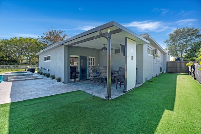 rear view of house featuring a lawn, a patio area, and ceiling fan