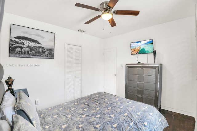 bedroom featuring a closet, ceiling fan, and dark hardwood / wood-style floors