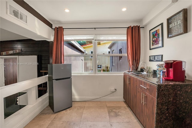 kitchen with sink and stainless steel refrigerator