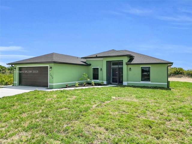 view of front of home featuring a garage, concrete driveway, a front lawn, roof with shingles, and stucco siding
