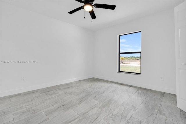unfurnished room featuring baseboards and a ceiling fan